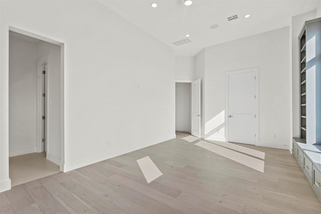 interior space with baseboards, light wood-style flooring, visible vents, and recessed lighting