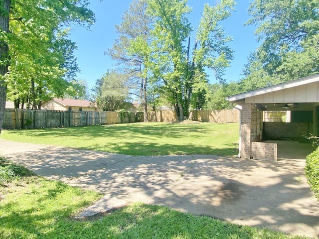 view of yard with a fenced backyard, a patio area, and a ceiling fan