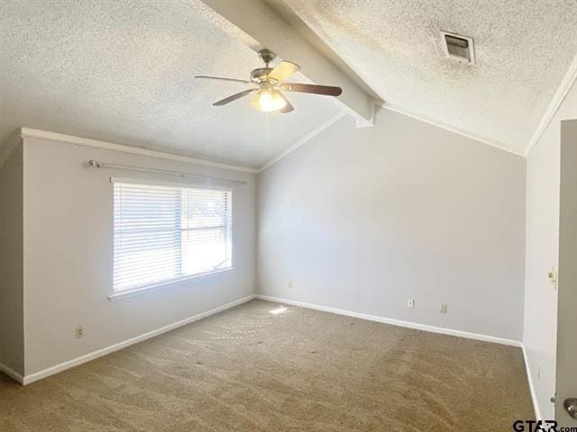 spare room with a textured ceiling, carpet flooring, ceiling fan, and visible vents