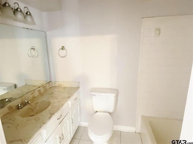 bathroom with tile patterned floors, baseboards, vanity, and toilet