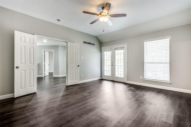 spare room featuring lofted ceiling, french doors, visible vents, and dark wood-style flooring