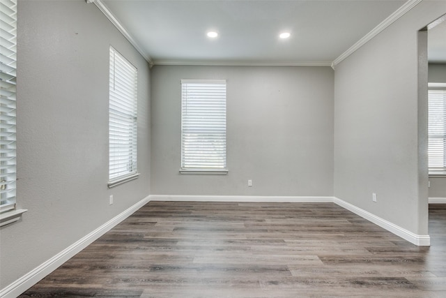 empty room with baseboards, recessed lighting, wood finished floors, and crown molding