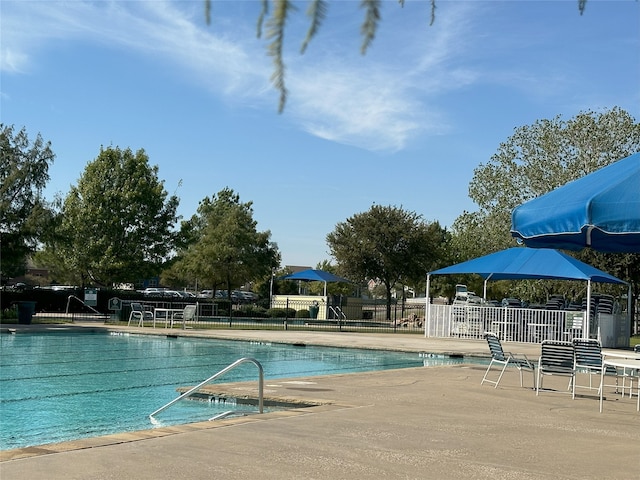 pool featuring a patio area and fence