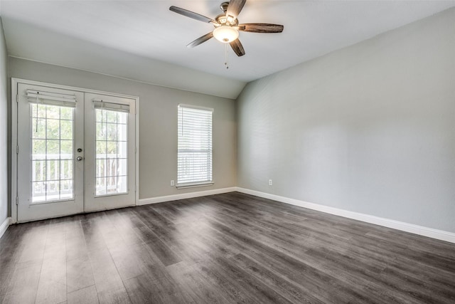 spare room featuring dark wood-style flooring, french doors, lofted ceiling, ceiling fan, and baseboards