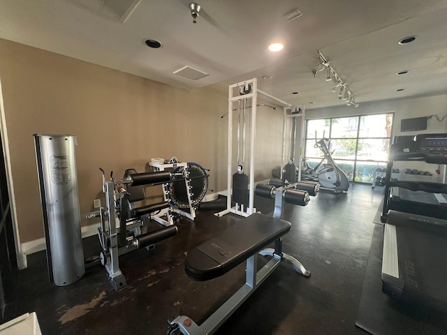 exercise room with baseboards and recessed lighting