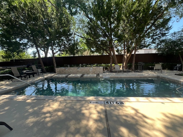 view of pool featuring a patio area, a fenced backyard, and a fenced in pool