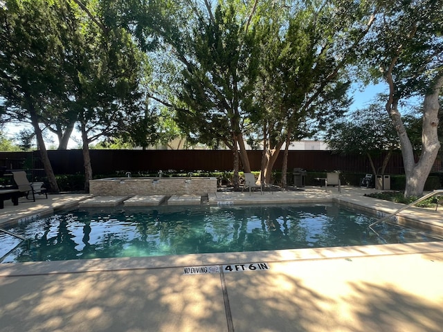 view of pool featuring a patio, a fenced backyard, and a fenced in pool