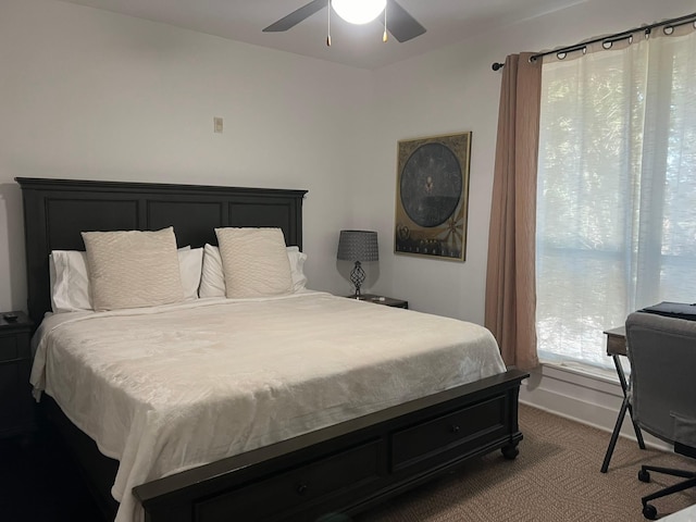 bedroom featuring a ceiling fan, dark carpet, and baseboards