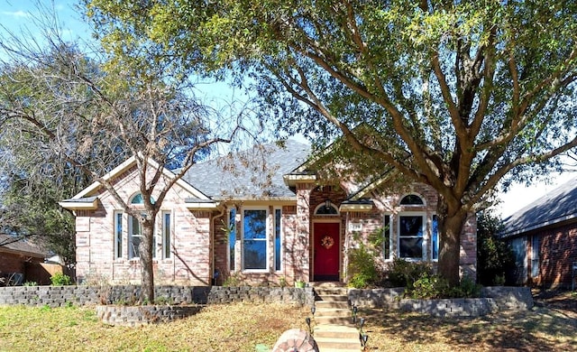 ranch-style house featuring brick siding