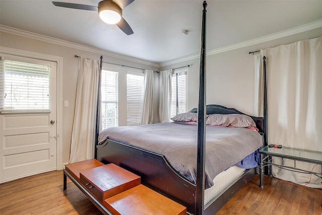 bedroom with ceiling fan, ornamental molding, and wood finished floors