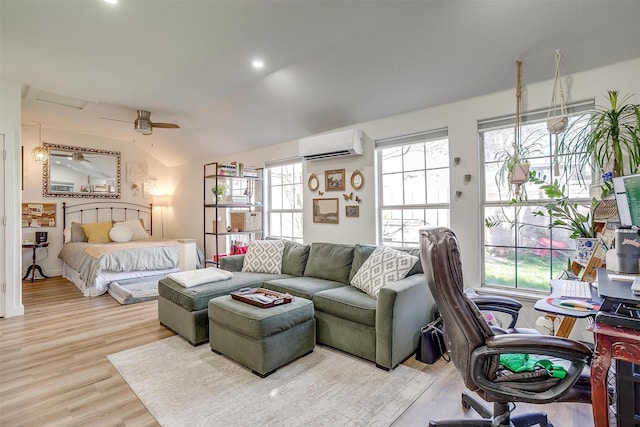 bedroom featuring vaulted ceiling, an AC wall unit, multiple windows, and wood finished floors