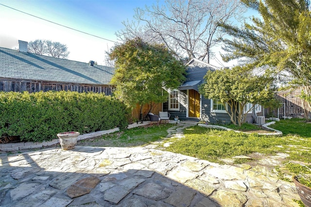 view of front of home with fence and a patio