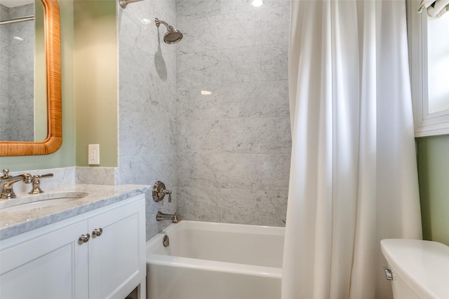 full bathroom featuring toilet, shower / bath combo with shower curtain, and vanity