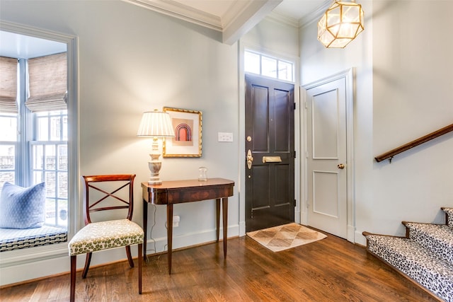 entryway featuring baseboards, crown molding, stairway, and wood finished floors