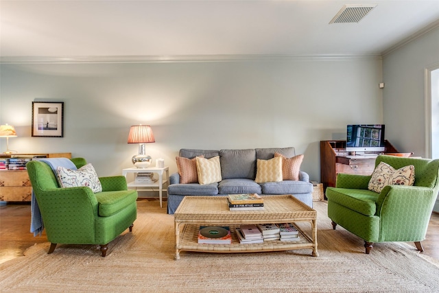 living area featuring ornamental molding and visible vents