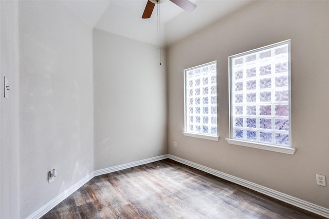 unfurnished room with a ceiling fan, baseboards, and wood finished floors