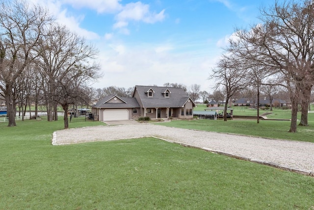 view of front of home featuring an attached garage, driveway, and a front lawn