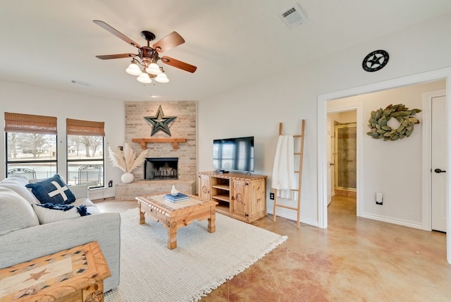 living area featuring a ceiling fan, visible vents, a fireplace, and baseboards