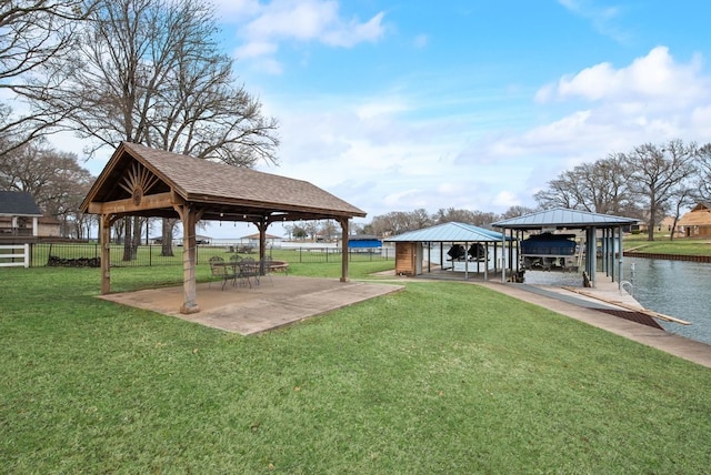 dock area featuring a yard, a gazebo, and fence