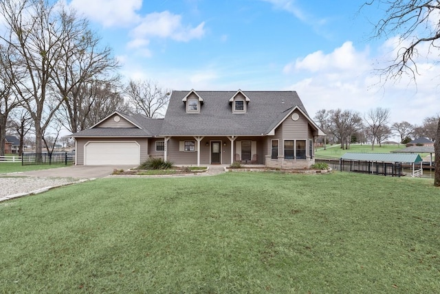 view of front of property featuring concrete driveway, roof with shingles, an attached garage, fence, and a front yard