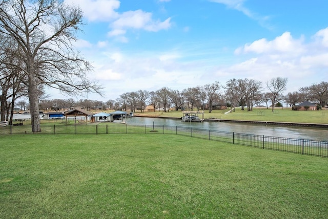 view of yard with a water view and fence