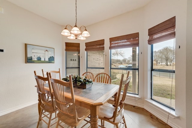 dining area with a notable chandelier and baseboards