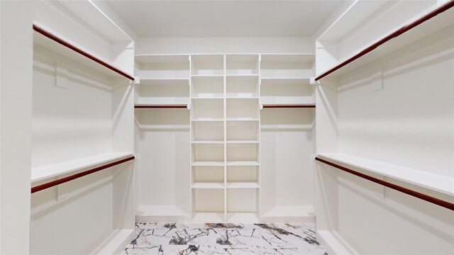 spacious closet featuring marble finish floor