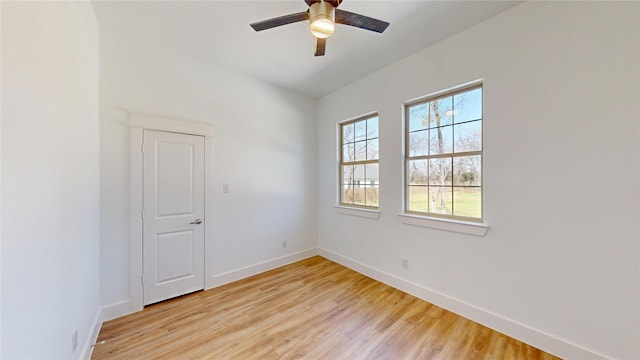 unfurnished room with a ceiling fan, baseboards, and light wood finished floors