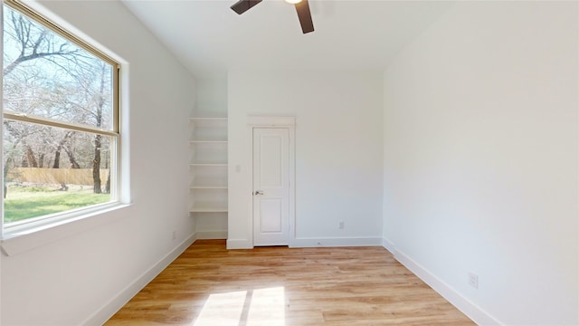 unfurnished bedroom featuring light wood finished floors, ceiling fan, and baseboards