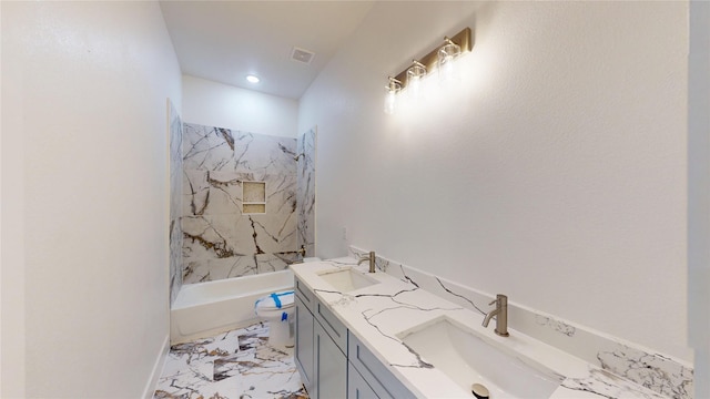 bathroom with toilet, marble finish floor, a sink, and visible vents