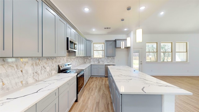 kitchen with visible vents, appliances with stainless steel finishes, and gray cabinetry