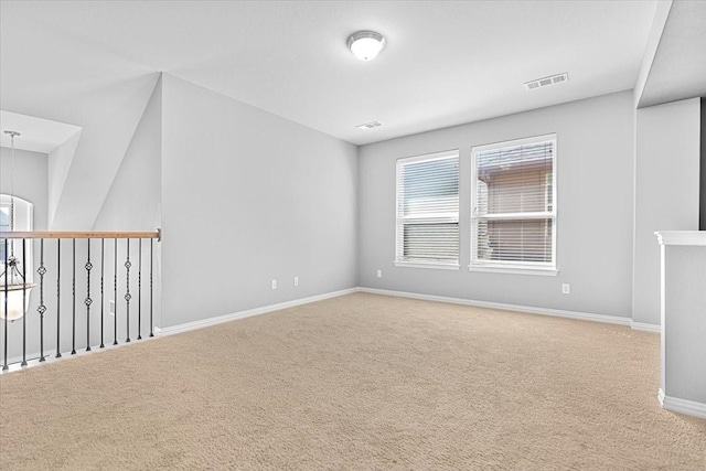 carpeted empty room with baseboards and visible vents