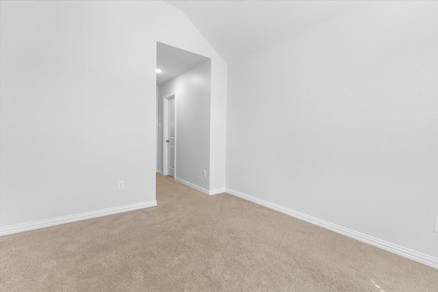 unfurnished room featuring vaulted ceiling, recessed lighting, light carpet, and baseboards