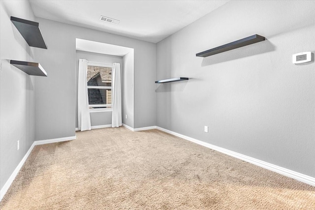 interior space with carpet floors, baseboards, and visible vents