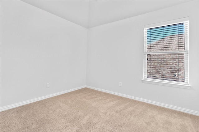 carpeted empty room with baseboards