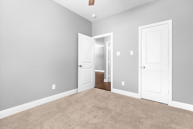 unfurnished bedroom with carpet floors, ceiling fan, and baseboards