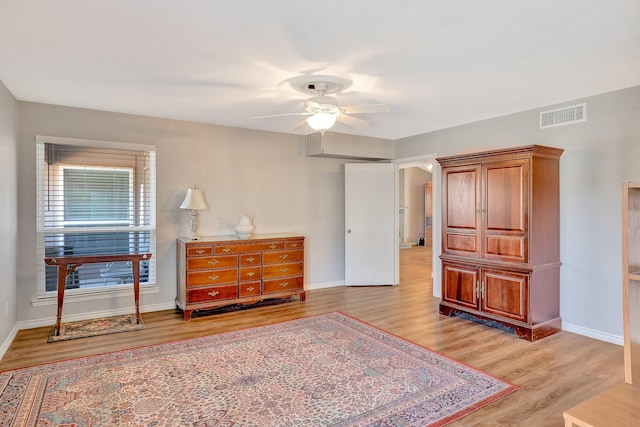 bedroom featuring ceiling fan, light wood finished floors, visible vents, and baseboards