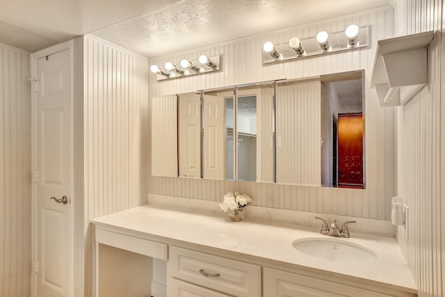 bathroom featuring a textured ceiling and vanity