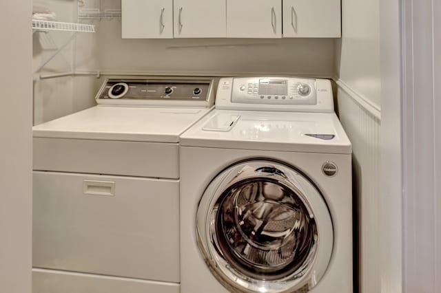 laundry room with cabinet space and washing machine and clothes dryer