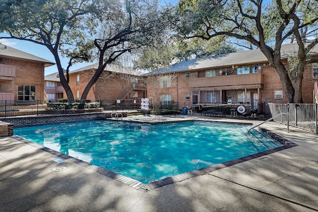 pool featuring a patio and fence