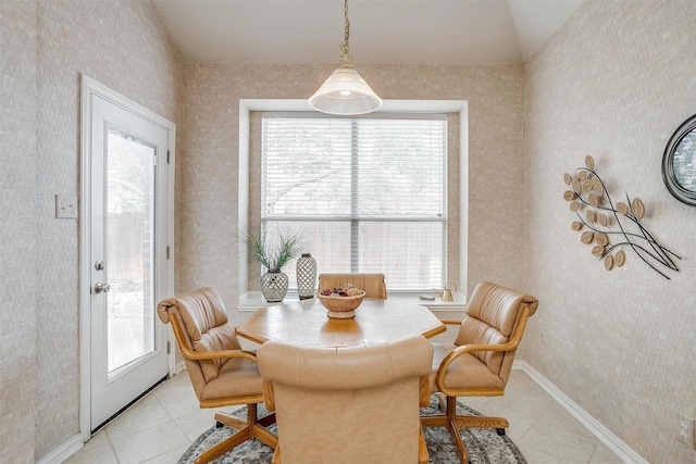 dining space featuring light tile patterned floors, plenty of natural light, and baseboards