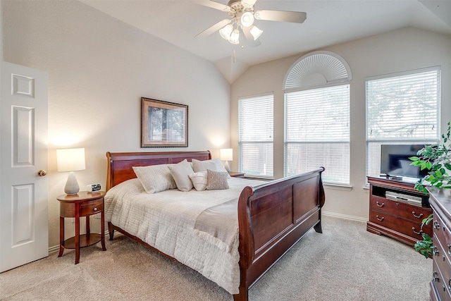 bedroom featuring a ceiling fan, light colored carpet, vaulted ceiling, and baseboards