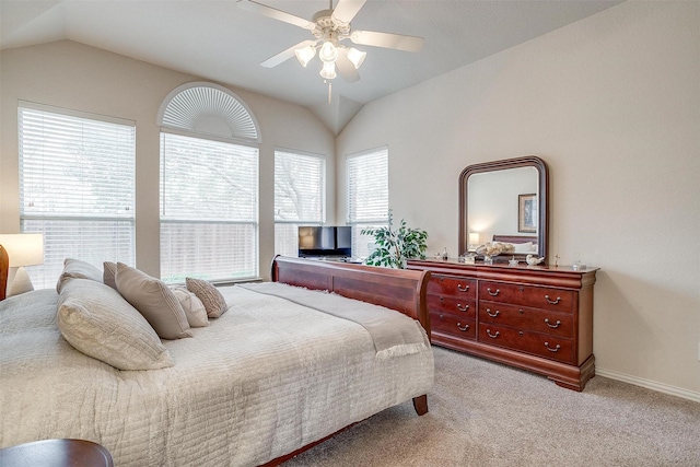 bedroom with lofted ceiling, ceiling fan, baseboards, and light colored carpet