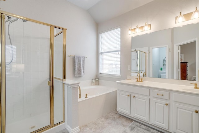 full bathroom with a sink, vaulted ceiling, a shower stall, a bath, and double vanity