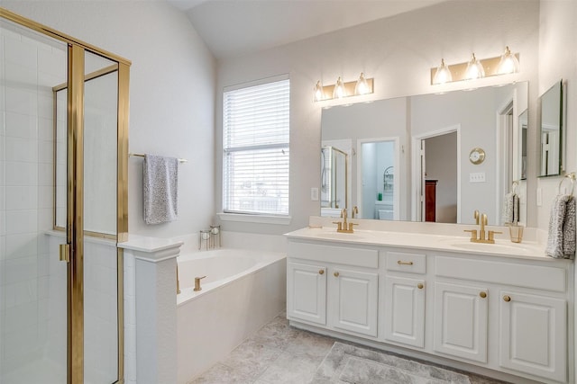 bathroom with a bath, a shower stall, double vanity, and a sink