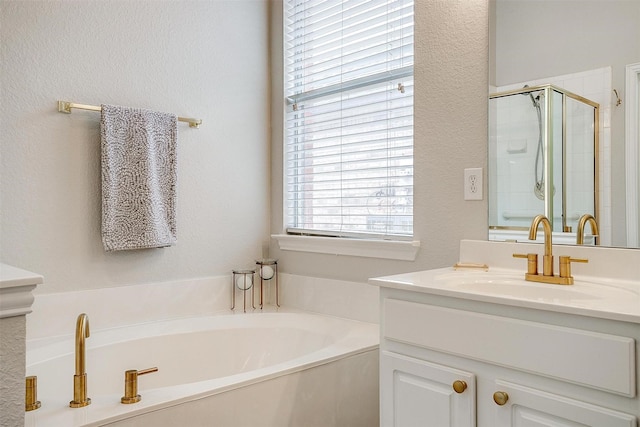 full bath with a stall shower, a textured wall, vanity, and a bath