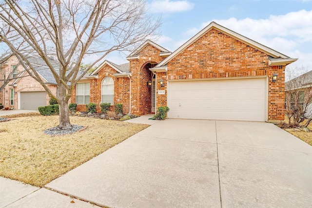 view of front facade with driveway, a garage, and brick siding