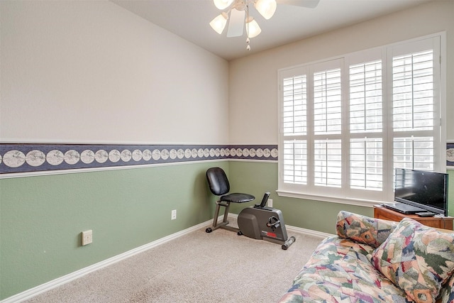 sitting room featuring carpet, plenty of natural light, baseboards, and ceiling fan