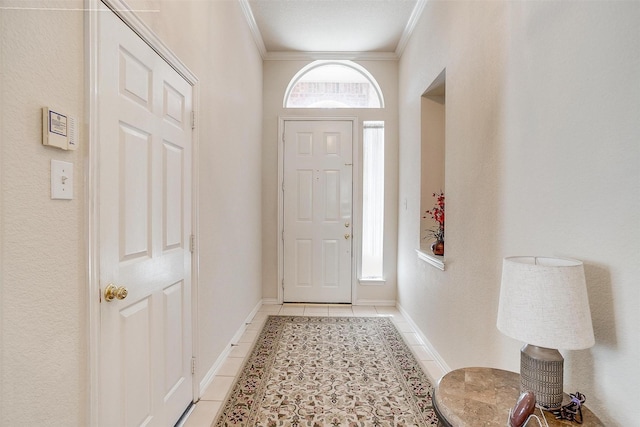 foyer with baseboards, ornamental molding, and light tile patterned flooring