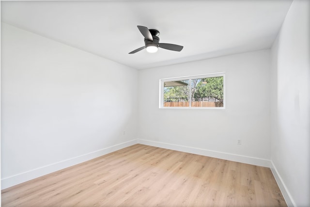 empty room with light wood finished floors, ceiling fan, and baseboards